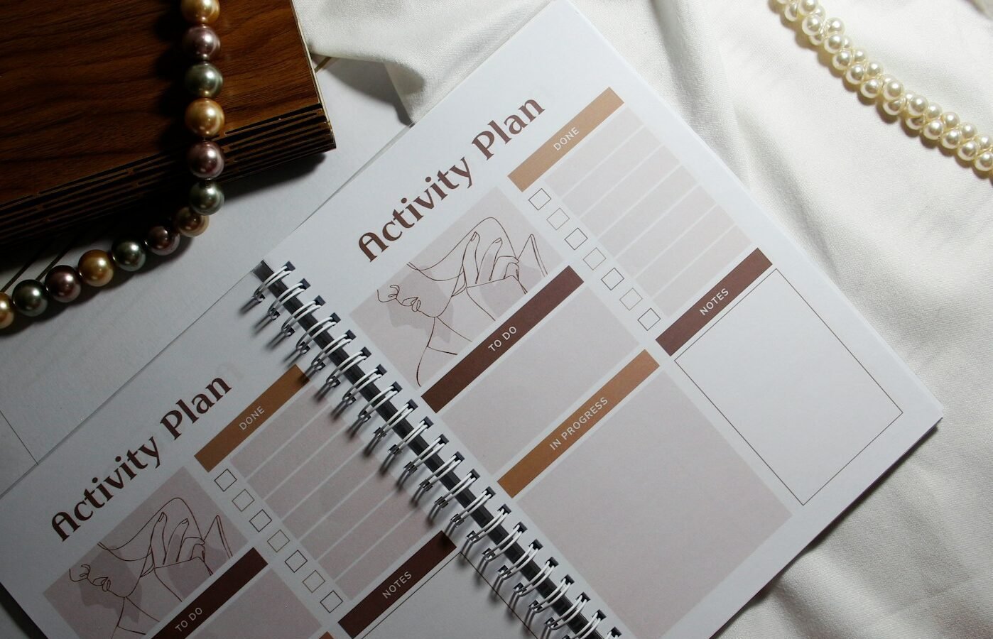 an activity plan with beads and a necklace on a bed